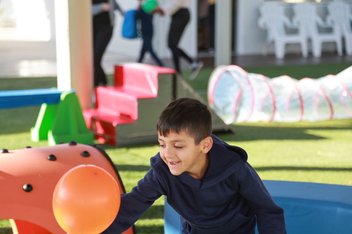 Student chasing a balloon in the playground
